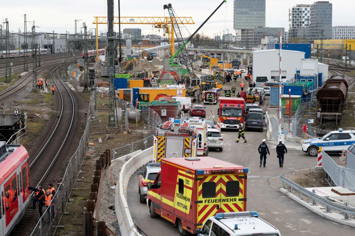 Police and firefighters secure the scene after an old aircraft bomb exploded at a bridge near Munich's busy main train station, in Munich, Germany, on Dec. 1, 2021. (Andreas Gebert/Reuters)