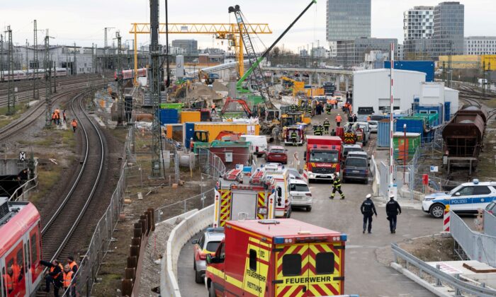 Police and firefighters secure the scene after an old aircraft bomb exploded at a bridge near Munich's busy main train station, in Munich, Germany, on Dec. 1, 2021. (Andreas Gebert/Reuters)