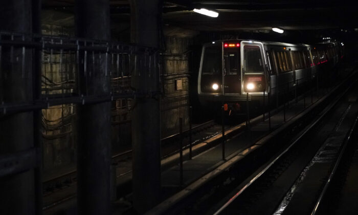 A Washington Metro train pulls into Dupont Circle station in D.C., on Nov. 24, 2021. (Patrick Semansky/AP Photo)