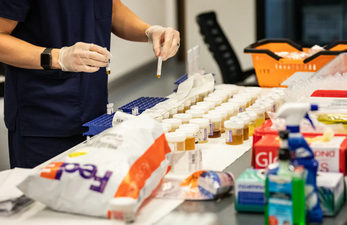 Equaltox Laboratory personel test samples for coronavirus in Tustin, Calif., on Sept. 3, 2020. (John Fredricks/The Epoch Times)