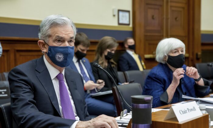 Federal Reserve Chairman Jerome Powell and Treasury Secretary Janet Yellen listen to lawmakers on Capitol Hill in D.C., on Dec. 1, 2021. (Amanda Andrade-Rhoades/AP Photo)