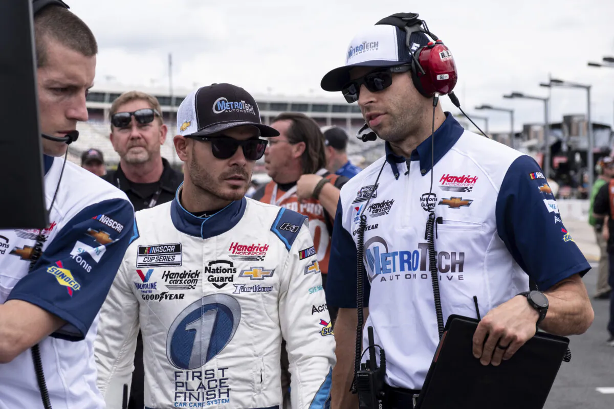 Kyle Larson, center, talks with his crew chief Cliff Daniels, right, before qualifying for the NASCAR Cup Series auto race in Charlotte, N.C., on May 29, 2021. (Ben Gray/AP Photo)
