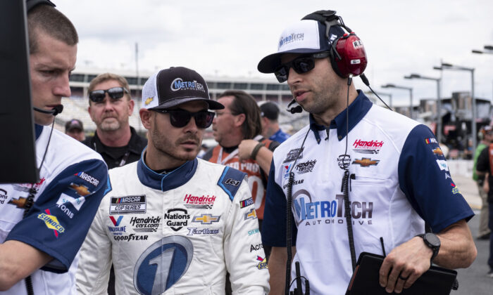 Kyle Larson, center, talks with his crew chief Cliff Daniels, right, before qualifying for the NASCAR Cup Series auto race in Charlotte, N.C., on May 29, 2021. (Ben Gray/AP Photo)