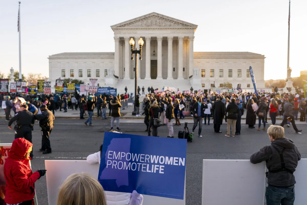 Pro-abortion advocates and pro-life protesters demonstrate in front of the U.S. Supreme Court in Washington on Dec. 1, 2021. (Andrew Harnik/AP Photo)