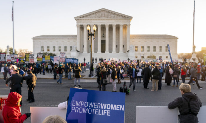 Pro-abortion advocates and pro-life protesters demonstrate in front of the U.S. Supreme Court in Washington on Dec. 1, 2021. (Andrew Harnik/AP Photo)