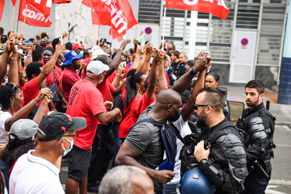 Protesters take part in a demonstration against compulsory Covid-19 vaccinations in front of the Prefecture of Martinique in Fort-de-France, on the French Caribbean island of Martinique, on Nov. 30, 2021. (Alain Jocard/AFP via Getty Images)
