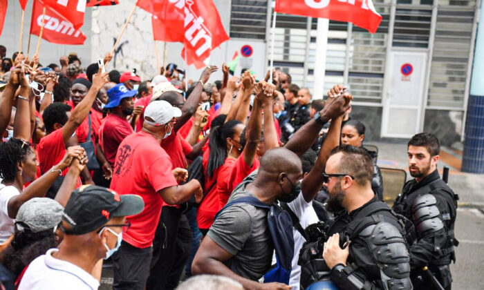 Protesters take part in a demonstration against compulsory Covid-19 vaccinations in front of the Prefecture of Martinique in Fort-de-France, on the French Caribbean island of Martinique, on Nov. 30, 2021. (Alain Jocard/AFP via Getty Images)