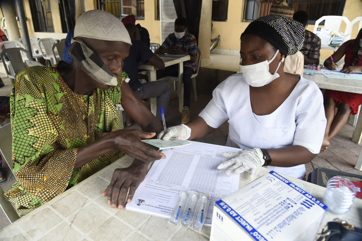 A man gets a COVID-19 vaccination card in Lagos, Nigeria, on Nov. 26, 2021. (Pius Utomi Ekpei/AFP via Getty Images)