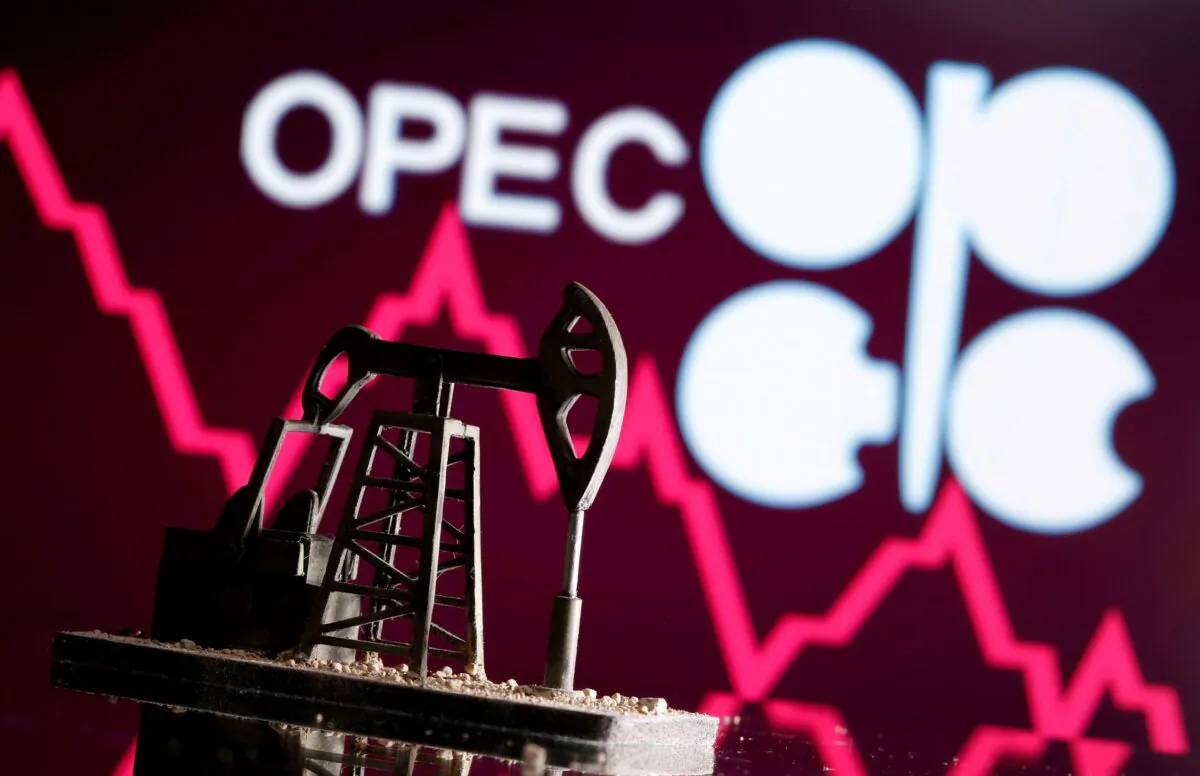 A 3D-printed oil pump jack is seen in front of the OPEC logo in this illustration picture taken on April 14, 2020. (Dado Ruvic/Reuters)