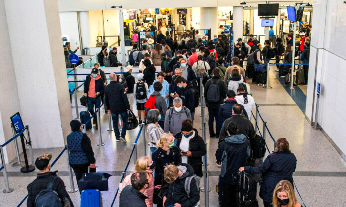 Passengers wait in line inside the terminal at Newark Liberty International Airport in Newark, New Jersey, on Nov. 24, 2021. (Eduardo Munoz/Reuters)
