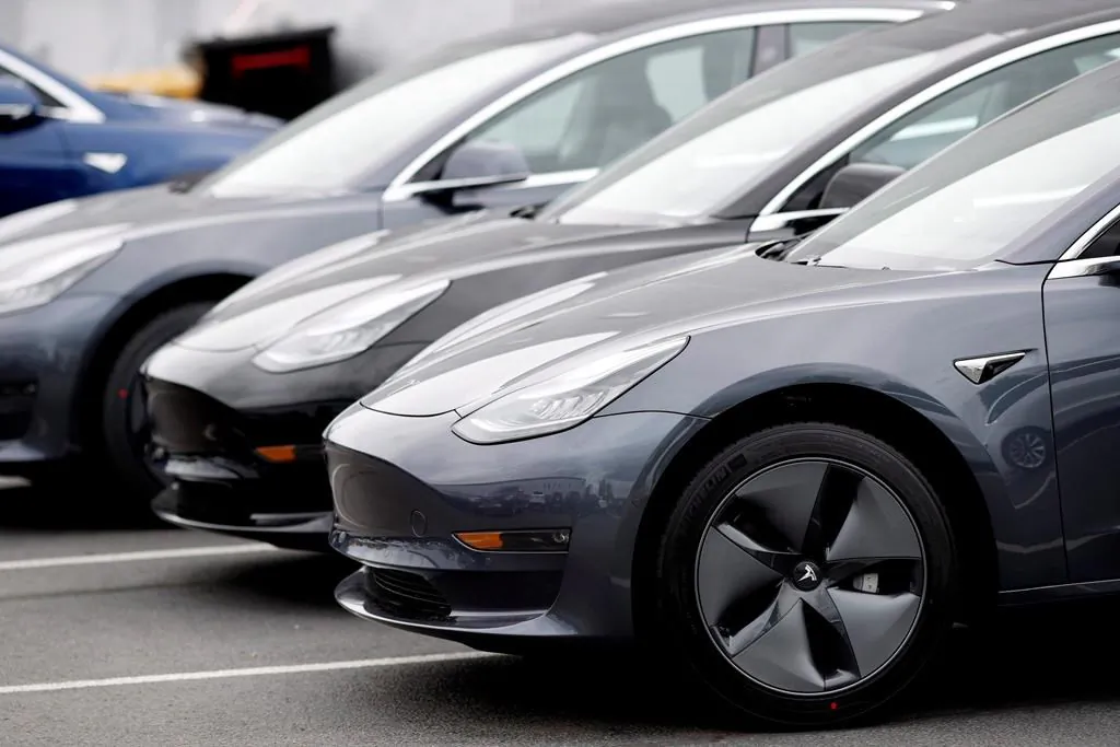 In this May 19, 2019, file photo, a line of unsold 2019 Model 3 sedans sits at a Tesla dealership in Littleton, Colo. (AP Photo/David Zalubowski, File)