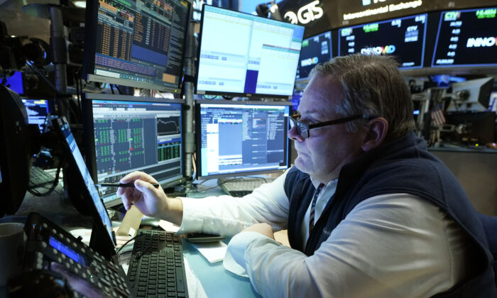 Trader Michael Conlon works on the floor of the New York Stock Exchange, in New York City, on Dec. 1, 2021. (Richard Drew/AP Photo)