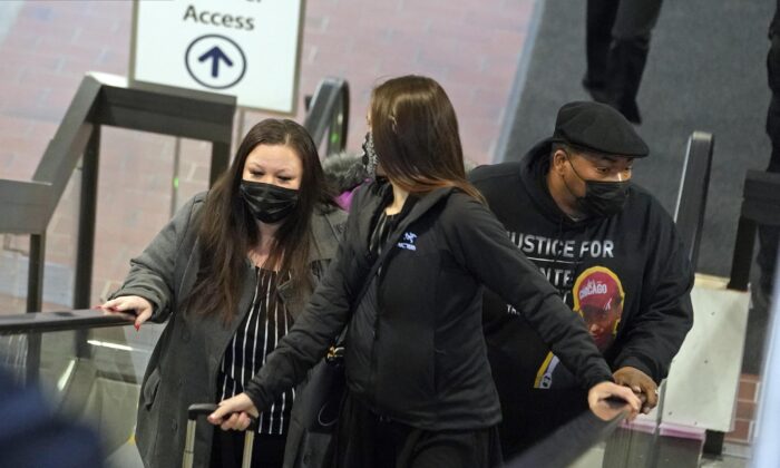 Katie Wright, the mother of Daunte Wright, left, and his father, Arbuey Wright, right, arrive at the Hennepin County Government Center in Minneapolis, on Dec. 2, 2021. (Jim Mone/AP Photo)