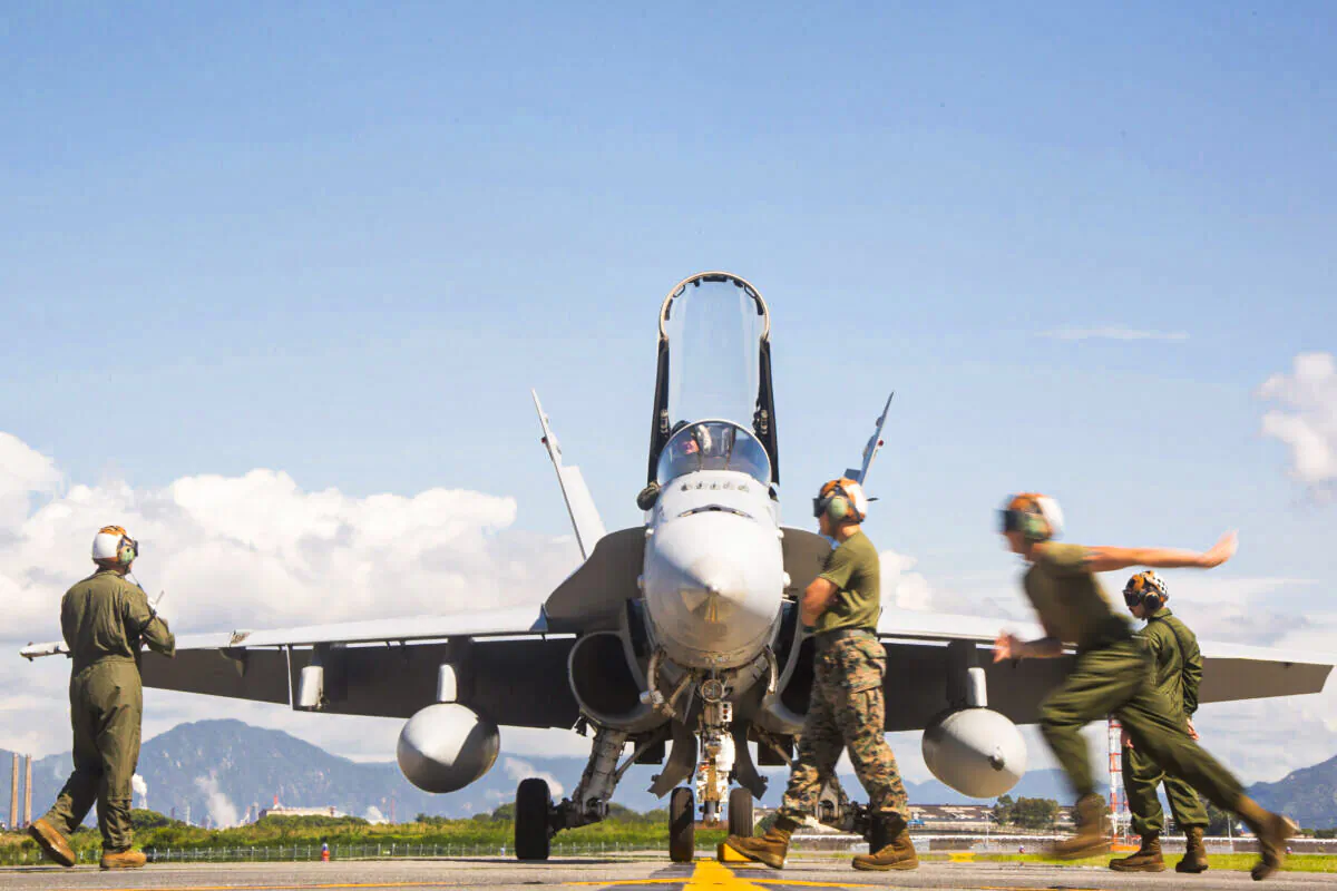 Flight crew with Marine Fighter Attack Squadron 112 (VMFA-112) conducts pre-flight checks and prepares an F/A-18 Hornet for launch, on Sept. 23, 2021. (U.S. Marine Corps / Sgt. Booker T. Thomas)