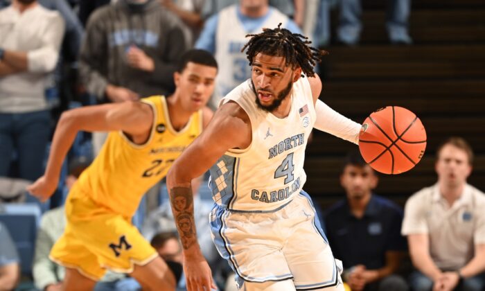 North Carolina Tar Heels guard R.J. Davis (4) with the ball as Michigan Wolverines forward Caleb Houstan (22) defends in the second half at Dean E. Smith Center in Chapel Hill, N.C., on Dec 1, 2021. (Bob Donnan/USA TODAY Sports via Field Level Media)