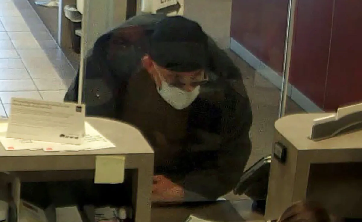 In this image taken from bank surveillance video and released by the City of Clearwater-Public Safety, David Marc Ratcliff approaches a teller at a Wells Fargo bank as he robs the bank in Clearwater, Fla., on Nov. 30, 2021. (City of Clearwater-Public Safety via AP)