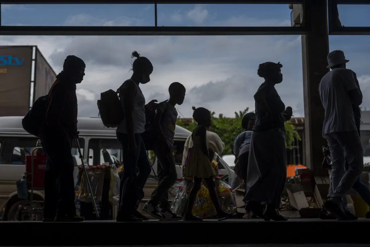 Passengers line up to board a taxi in Soweto, South Africa on Dec. 2, 2021. (Jerome Delay/AP Photo)