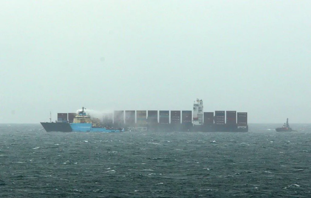 Ships continue to work to control a fire onboard the MV Zim Kingston about eight kilometres from the shore in Victoria, B.C., October 25, 2021. (The Canadian Press/Chad Hipolito)