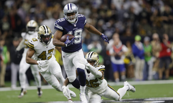 Dallas Cowboys wide receiver Amari Cooper (19) runs against New Orleans Saints cornerback P.J. Williams (26) during the first half of an NFL football game, in New Orleans, on Dec. 2, 2021. (Brett Duke/AP Photo).