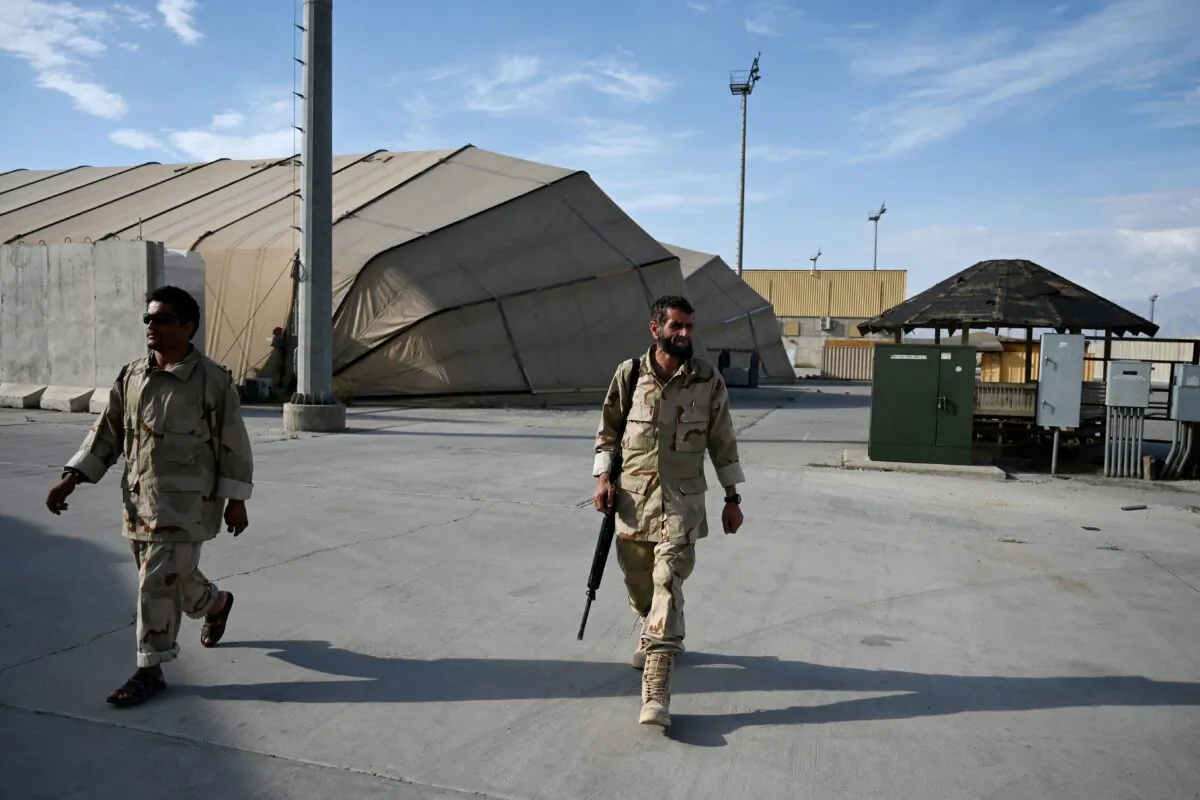 Afghan National Army soldiers walk inside the Bagram US air base after all US and NATO troops left, some 43 miles north of Kabul on July 5, 2021. (Wakil Kohsar/AFP via Getty Images)