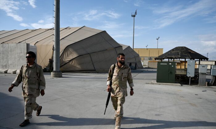 Afghan National Army soldiers walk inside the Bagram US air base after all US and NATO troops left, some 43 miles north of Kabul on July 5, 2021. (Wakil Kohsar/AFP via Getty Images)