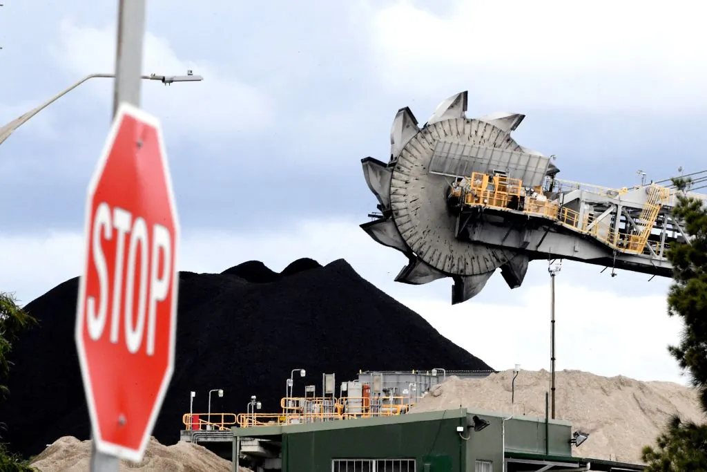 This picture shows a bucket-wheel dumping soil and sand removed from another area of the mine in Newcastle, New South Wales, in Australia, on Nov. 5, 2021. (Saeed Khan/AFP via Getty Images)