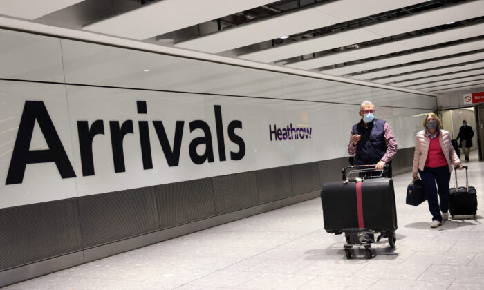 People arrive at Heathrow airport in west London on Nov. 30, 2021. (Adrian Dennis/ AFP via Getty Images)