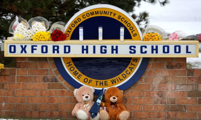 Stuffed bears and flowers are gathered at a makeshift memorial outside of Oxford High School in Oxford, Mich., on Dec. 1, 2021. (Scott Olson/Getty Images)