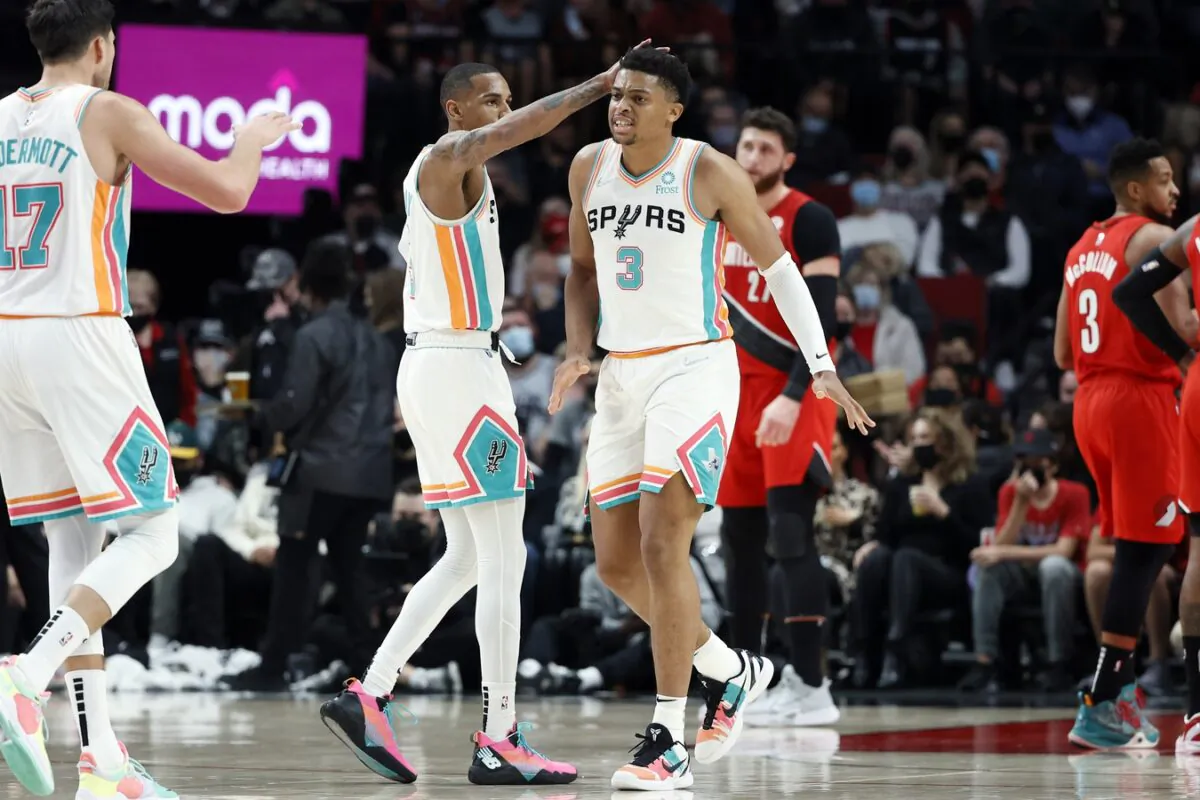 San Antonio Spurs small forward Keldon Johnson (3) celebrates a basket and a foul with teammate at Moda Center, in Portland, Ore., on Dec. 2, 2021. (Soobum Im/USA TODAY Sports via Field Level Media)