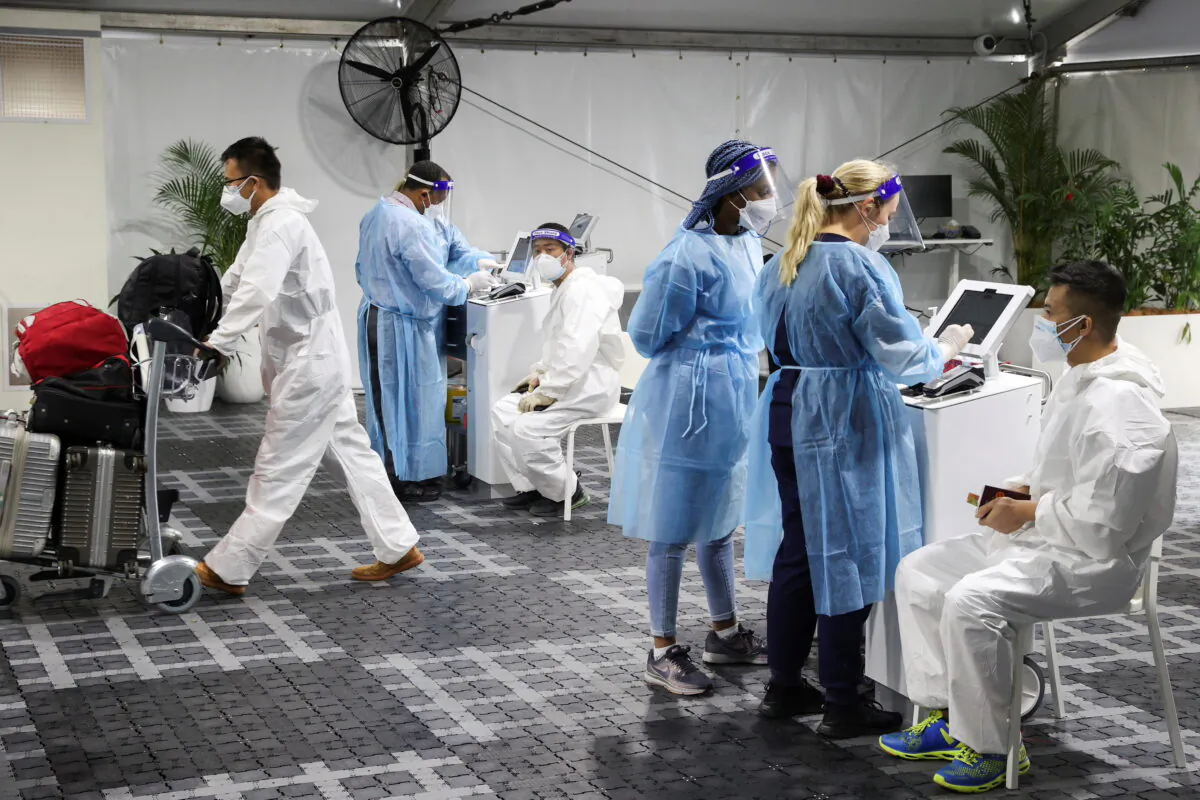 Travelers receive tests COVID-19 at a pre-departure testing facility, as countries react to the new Omicron variant, outside the international terminal at Sydney Airport in Australia, on Nov. 29, 2021. (Loren Elliott/Reuters)