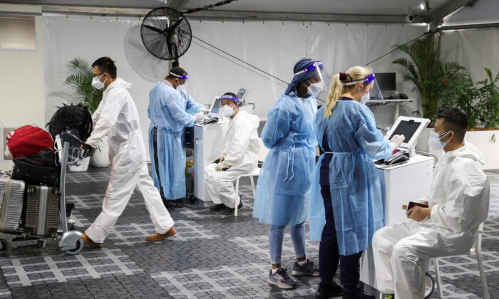 Travelers receive COVID-19 tests at a pre-departure testing facility, as countries react to the new Omicron variant, outside the international terminal at Sydney Airport in Australia on Nov. 29, 2021. (Loren Elliott/Reuters)