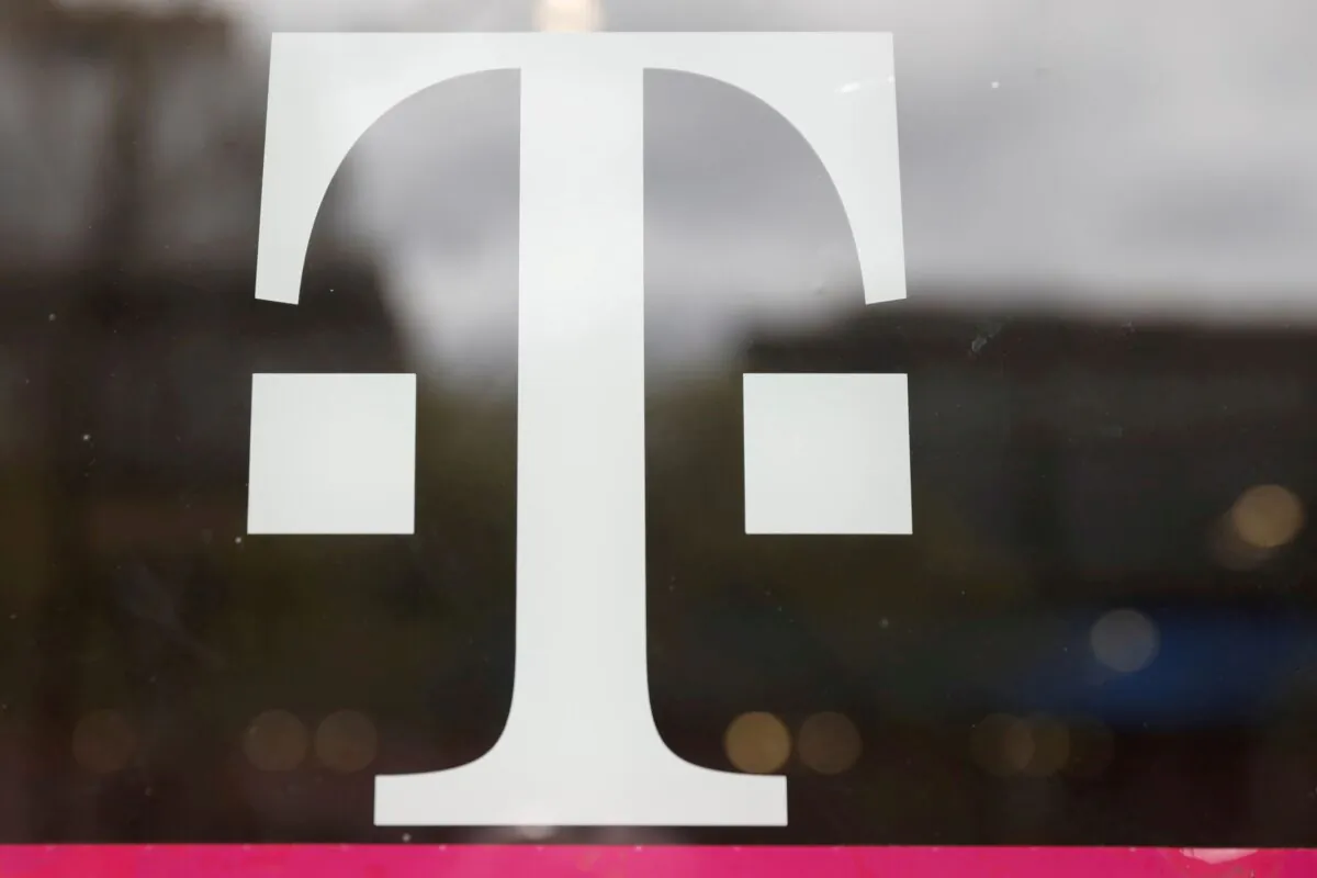 A T-Mobile logo is seen on the storefront door of a store in Manhattan, N.Y., on April 30, 2018. (Shannon Stapleton/Reuters)