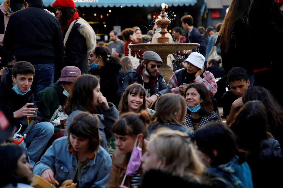 People enjoy an evening drink at Place de la Contrescarpe in Paris as cafes, bars and restaurants reopen after closing down for months amid the coronavirus disease (COVID-19) outbreak in France, on May 19, 2021. (Sarah Meyssonnier/Reuters)