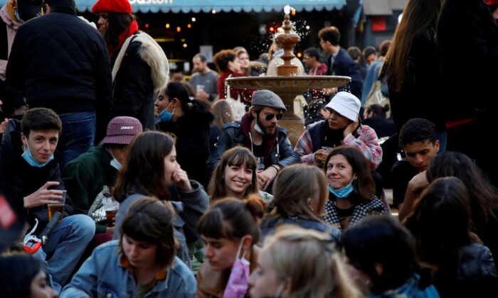 People enjoy an evening drink at Place de la Contrescarpe in Paris as cafes, as bars and restaurants reopen after closing down for months amid the coronavirus disease (COVID-19) outbreak in France, on May 19, 2021. (Sarah Meyssonnier/Reuters)