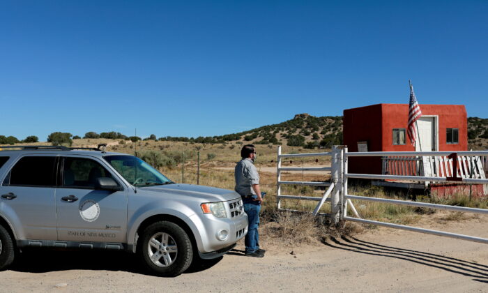 A compliance officer from the State of New Mexico waits to enter Bonanza Creek Ranch where on the film set of "Rust" Hollywood actor Alec Baldwin fatally shot cinematographer Halyna Hutchins and wounded a director when he discharged a prop gun on the movie set, in Santa Fe, N.M., on Oct. 22, 2021.  (Adria Malcolm/Reuters)