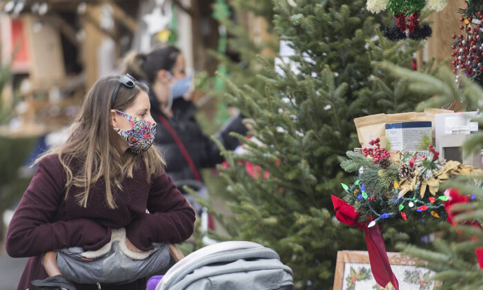 People wear face masks as they shop at a Christmas market in Montreal, on Nov. 28, 2020. (Graham Hughes/The Canadian Press)