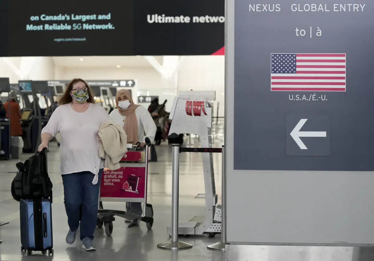 Travellers heading to the United States at Pearson International Airport in Toronto on Dec. 3, 2021. (Nathan Denette/The Canadian Press)