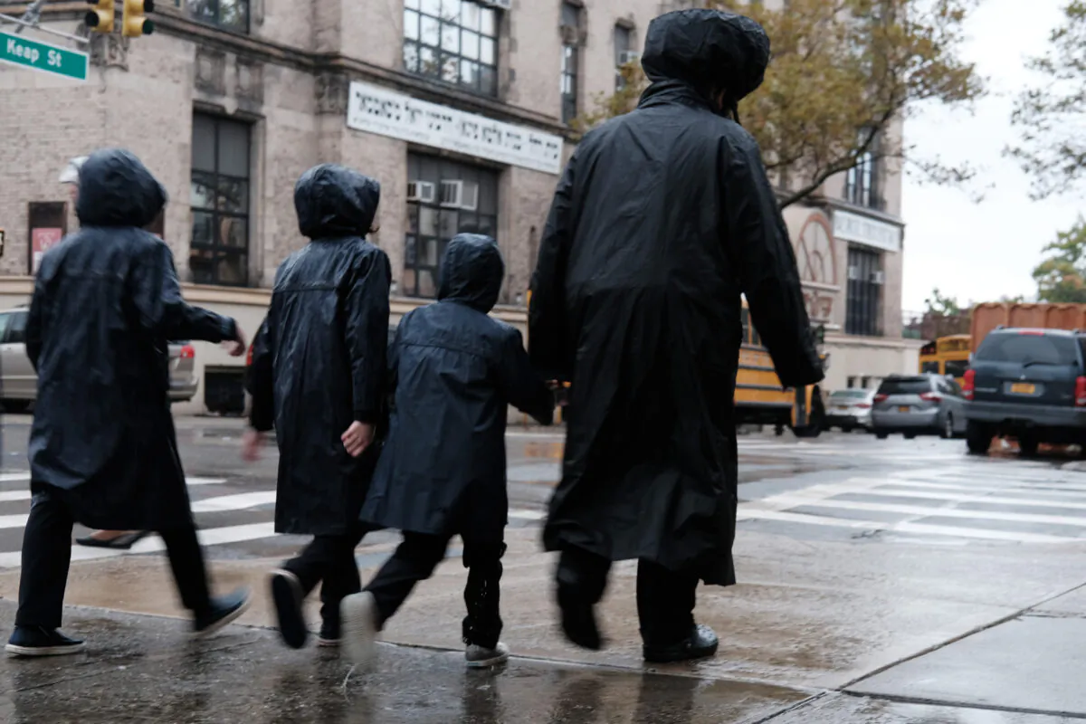 Members of the Jewish Orthodox community walk through a Brooklyn neighborhood on the Yom Kippur holiday, in New York City, on Oct. 9, 2019. (Spencer Platt/Getty Images)
