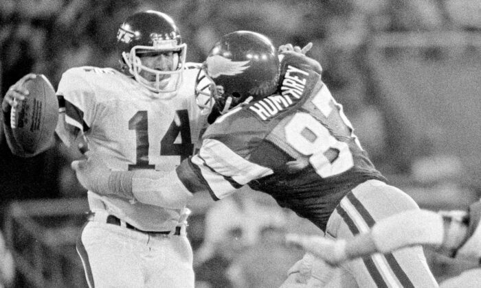 Philadelphia Eagles' Claude Humphrey (87) grabs New York Jets quarterback Richard Todd (14) and pulls him down for an 11-yard loss during an exhibition NFL football game in Philadelphia, on Aug. 15, 1980. (Clem Murray/AP Photo, File)