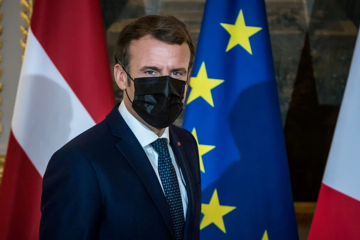 French President Emmanuel Macron wears a face mask as he arrives to deliver a statement with Latvian Prime Minister Krisjanis Karins at the Elysee Palace in Paris, France, on Dec. 1, 2021. (Christophe Petit Tesson/Pool via Reuters)