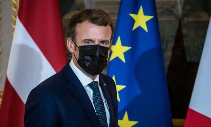 French President Emmanuel Macron wears a face mask as he arrives to deliver a statement with Latvian Prime Minister Krisjanis Karins at the Elysee Palace in Paris, France, on Dec. 1, 2021. (Christophe Petit Tesson/Pool via Reuters)