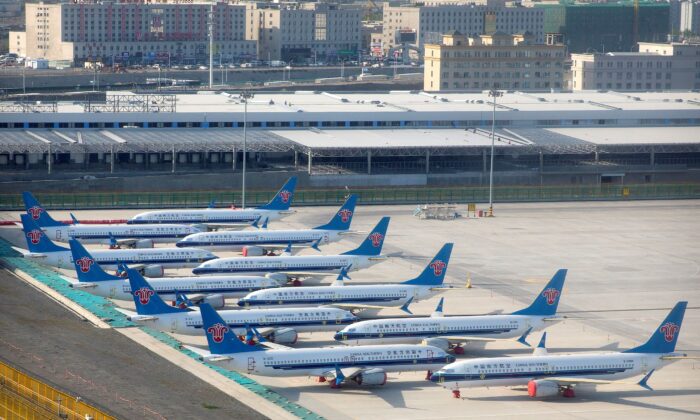 China Southern Airlines Boeing 737 Max airplanes are parked at the edge of the tarmac at Urumqi Diwopu Interational Airport in Urumqi in western China, on April 21, 2021. (Mark Schiefelbein/AP Photo)