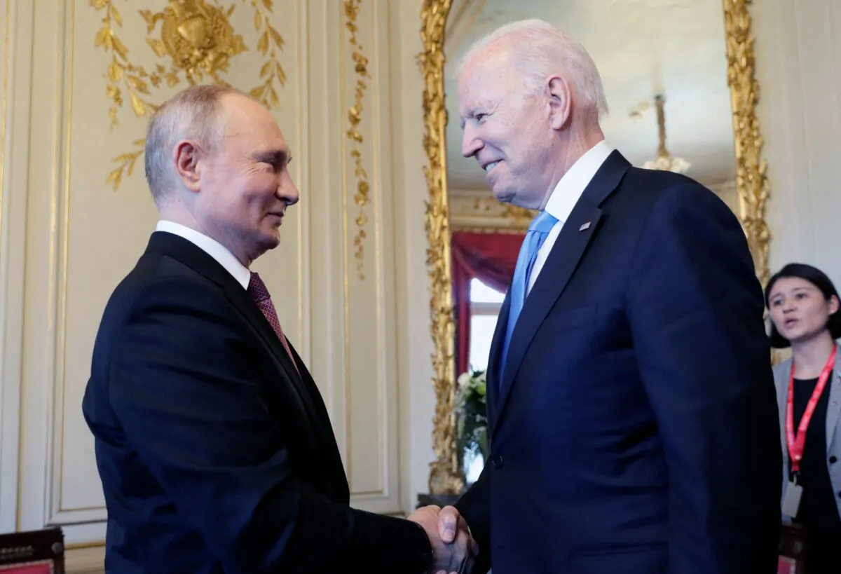 Russian President Vladimir Putin shakes hands with President Joe Biden during a meeting in Geneva, Switzerland, on June 16, 2021. (Mikhail Metzel/Sputnik/AFP via Getty Images)