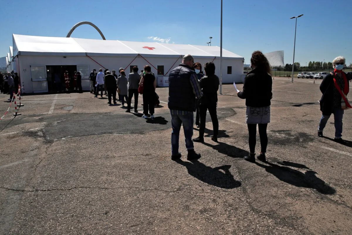 People wait in line at a COVID-19 vaccination center, near Tor Vergata hospital in Rome, on April 24, 2021. (Alessandra Tarantino/AP Photo)