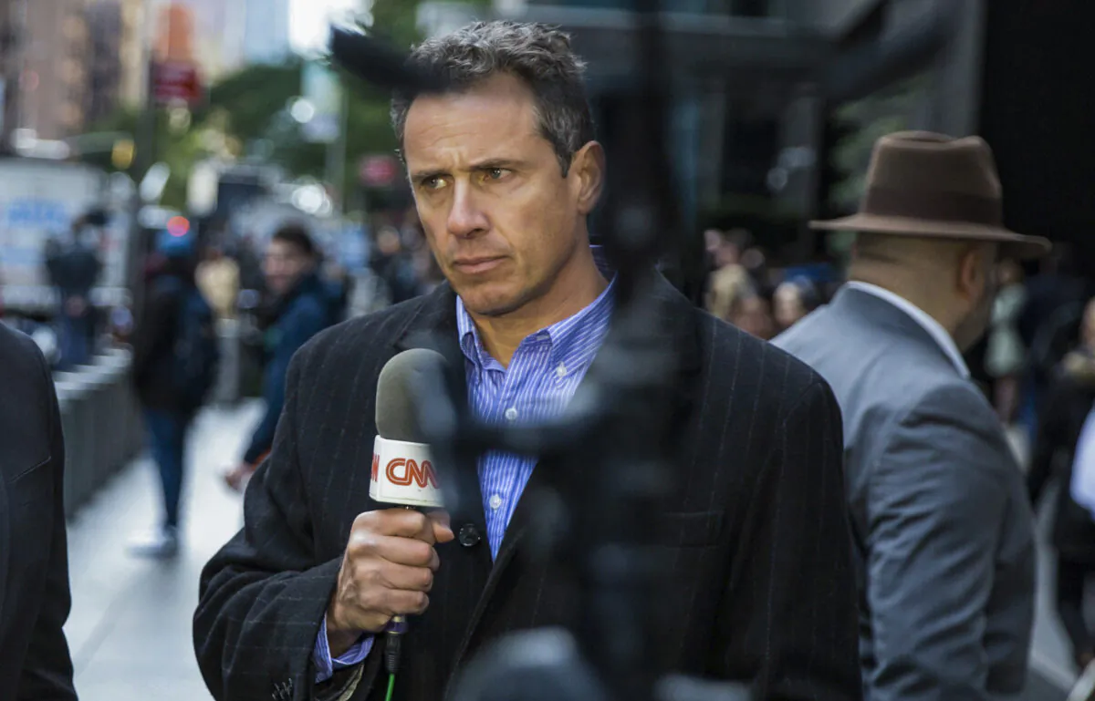 CNN correspondent Chris Cuomo during on air report in front of the Time Warner Building, where NYPD personnel removed an explosive device, in New York on Oct. 24, 2018. (Kevin Hagen/AP Photo)