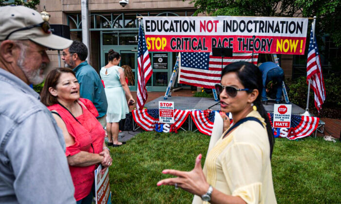 People talk before the start of a rally against "critical race theory" being taught in schools at the Loudoun County Government center in Leesburg, Va., on June 12, 2021. (Andrew Caballero-Reynolds/AFP via Getty Images)