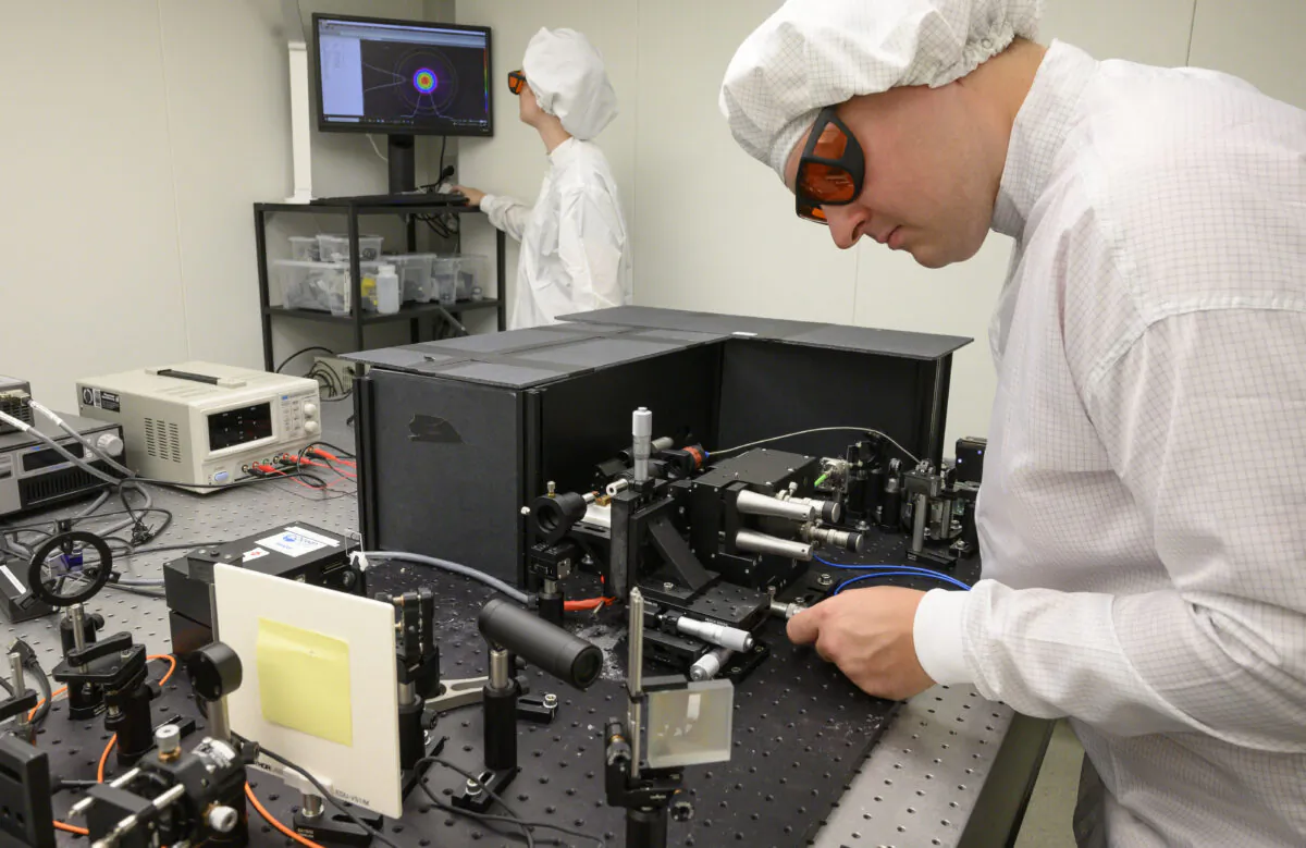 Engineer Kirill Spasibko (R) adjusts a laser to test chips with waveguides for quantum computing at the technology company Q.ant in Stuttgart, Germany, on September 14, 2021. - The company works on chips with customized waveguides for optical data processing, that are "considered the central building block for bringing quantum technologies out of the labs and into everyday products", according to the Q.ant. (Thomas Kienzele/AFP via Getty Images)