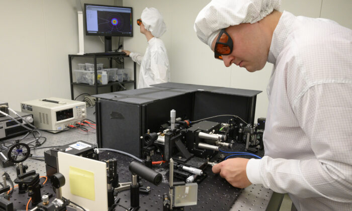 Engineer Kirill Spasibko (R) adjusts a laser to test chips with waveguides for quantum computing at the technology company Q.ant in Stuttgart, Germany, on September 14, 2021. - The company works on chips with customized waveguides for optical data processing, that are "considered the central building block for bringing quantum technologies out of the labs and into everyday products", according to the Q.ant. (Thomas Kienzele/AFP via Getty Images)