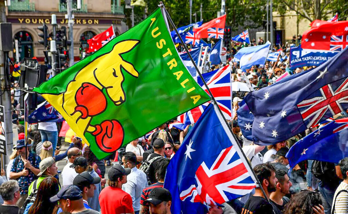 Protesters hold up placards during a rally against new pandemic laws and vaccination mandates in Melbourne on Dec. 4, 2021. (William West/AFP via Getty Images)