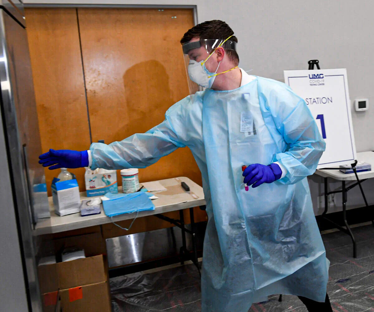 A supervisor puts a COVID-19 specimen sampling tube into a refrigerator at a testing site at the University of Nevada-Las Vegas on Nov. 30, 2020. (Ethan Miller/Getty Images)